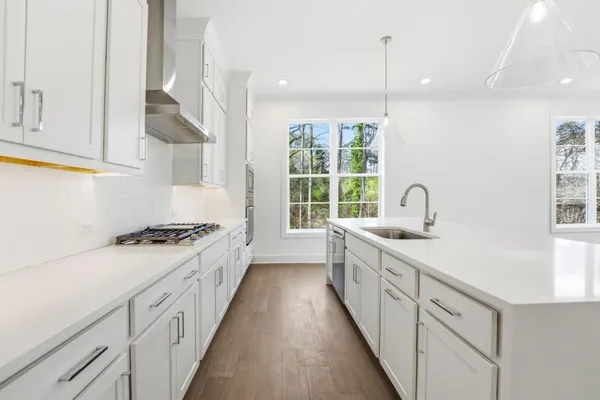 a kitchen with white cabinets and white appliances