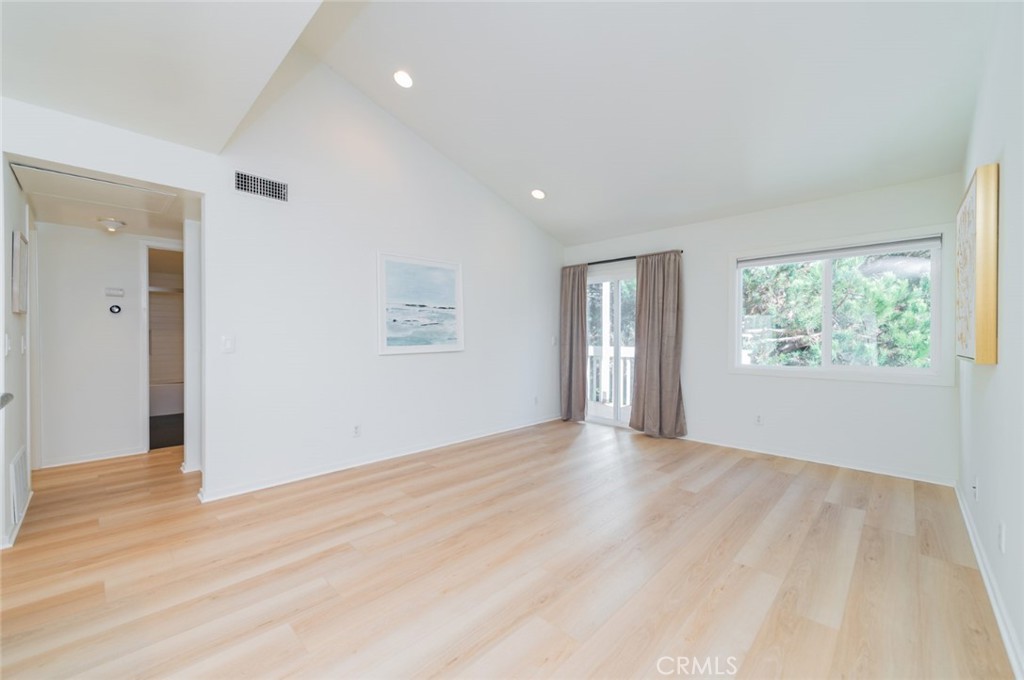 34028 Selva Road, Unit 77 Dana Point, CA 92629 - Photo 4 of 39 a view of an empty room with wooden floor and a window
