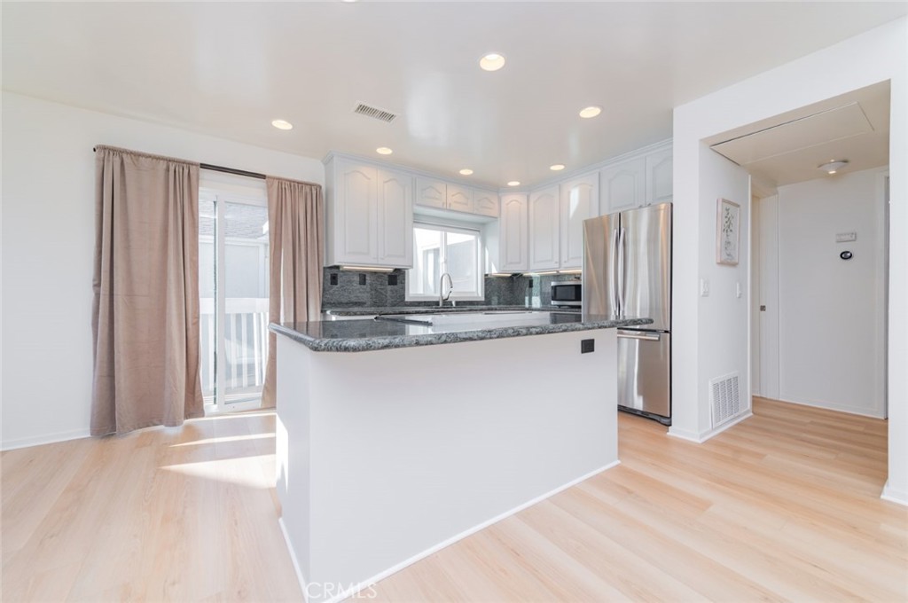34028 Selva Road, Unit 77 Dana Point, CA 92629 - Photo 7 of 39 a view of a kitchen with stainless steel appliances granite countertop a refrigerator and a sink