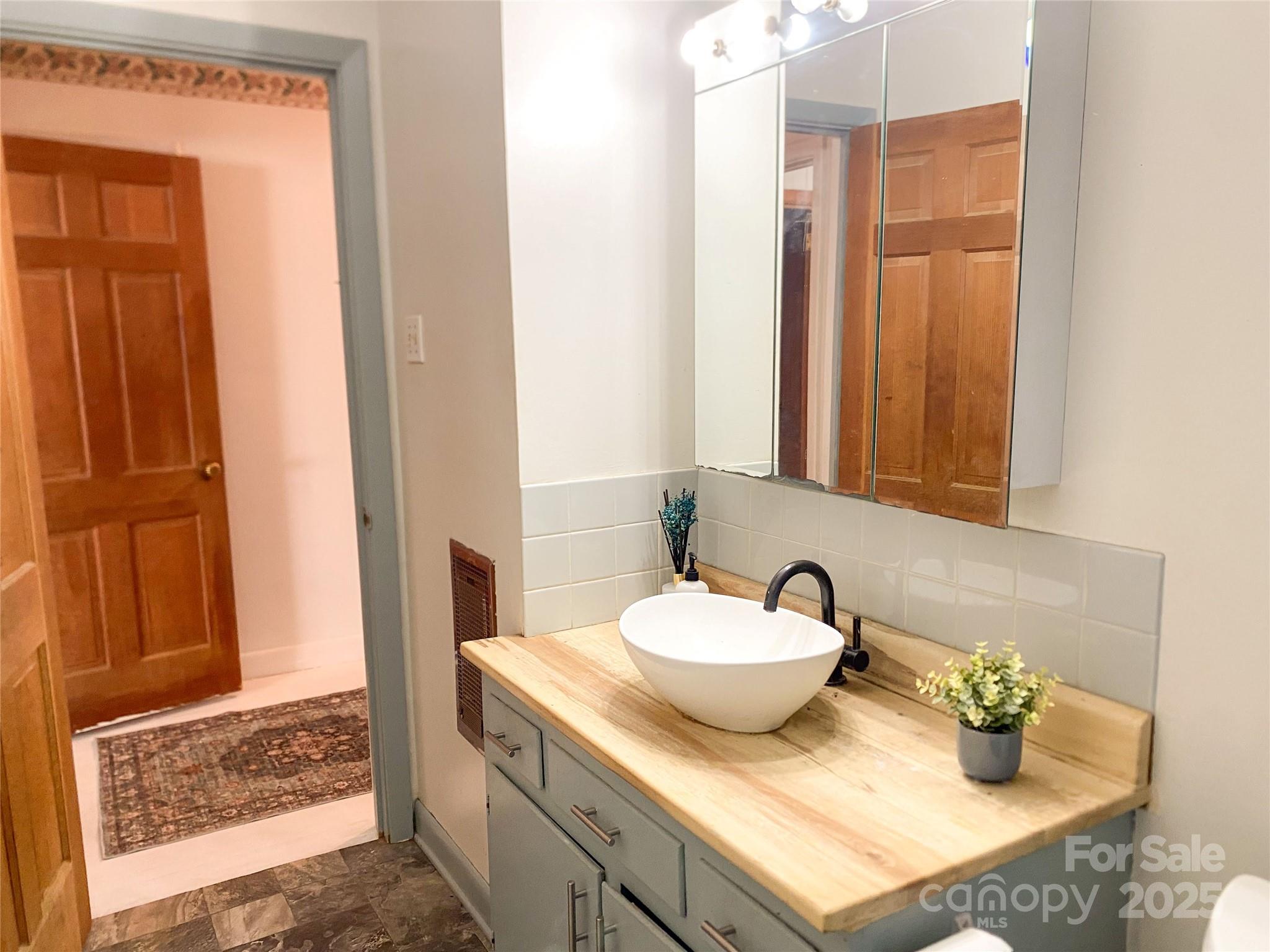 2855 Gheen Road Salisbury, NC 28147 - Photo 24 of 40 a bathroom with a granite countertop sink and a mirror
