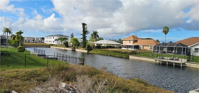 a view of a house with swimming pool and sitting area