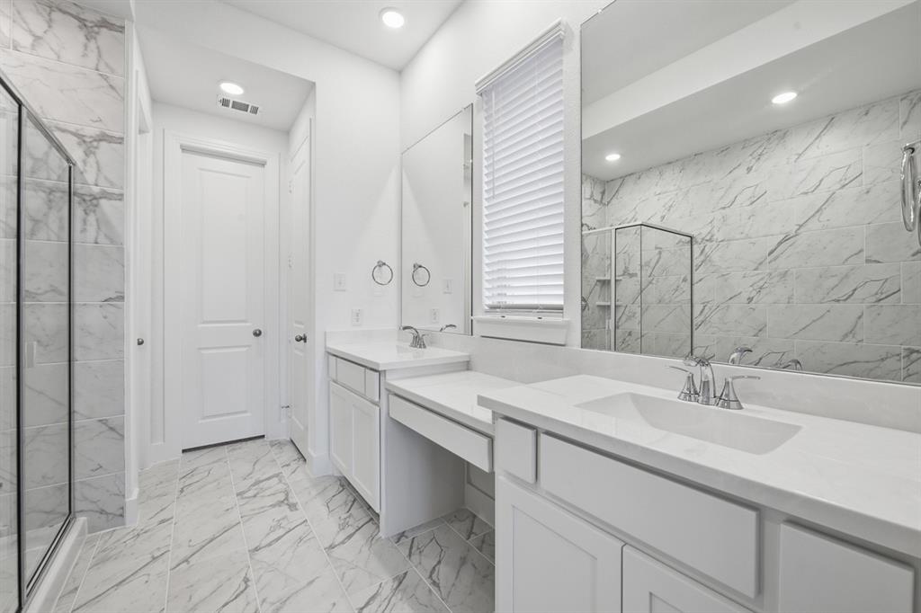 4107 Windy Point Court Oak Point, TX 75068 - Photo 13 of 30 a bathroom with a sink double vanity and a mirror