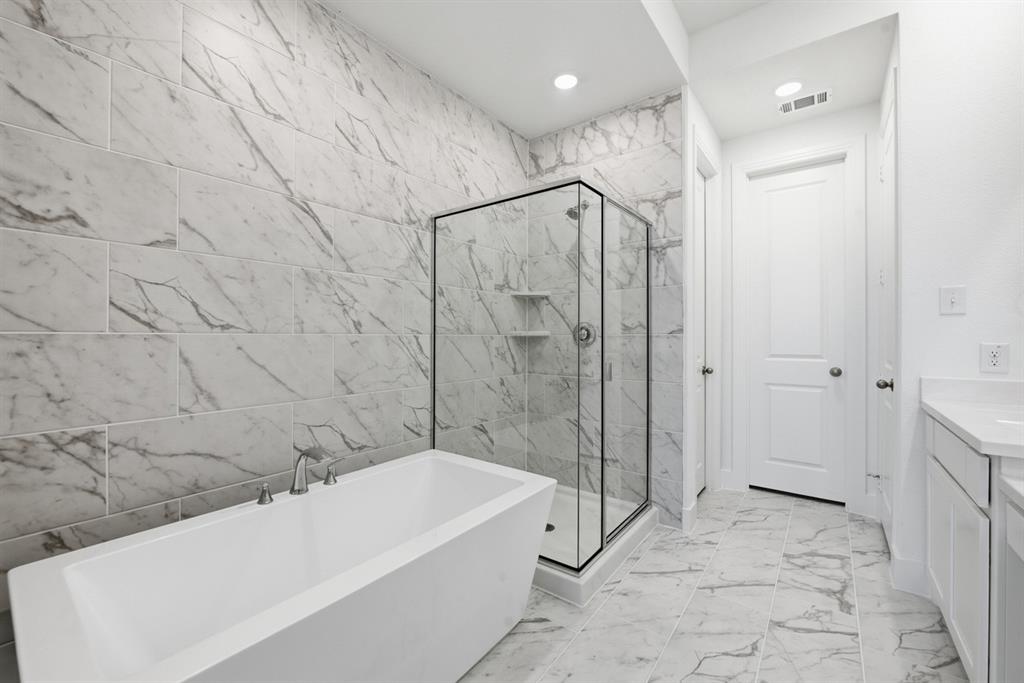 4107 Windy Point Court Oak Point, TX 75068 - Photo 14 of 30 a bathroom with a bathtub and a shower