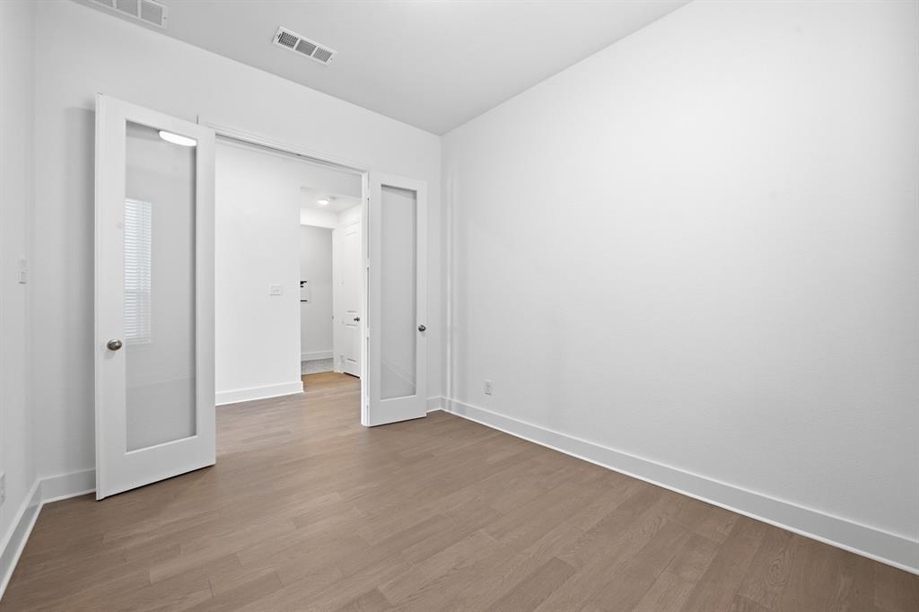 4107 Windy Point Court Oak Point, TX 75068 - Photo 17 of 30 a view of an empty room with wooden floor and closet