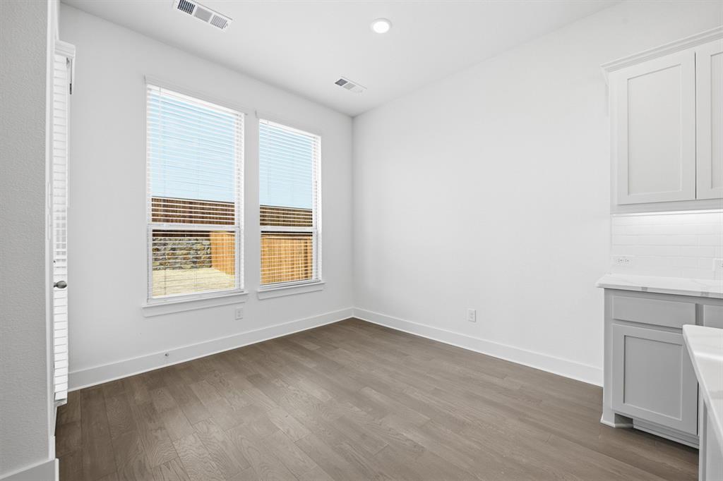 4107 Windy Point Court Oak Point, TX 75068 - Photo 18 of 30 an empty room with wooden floor and windows