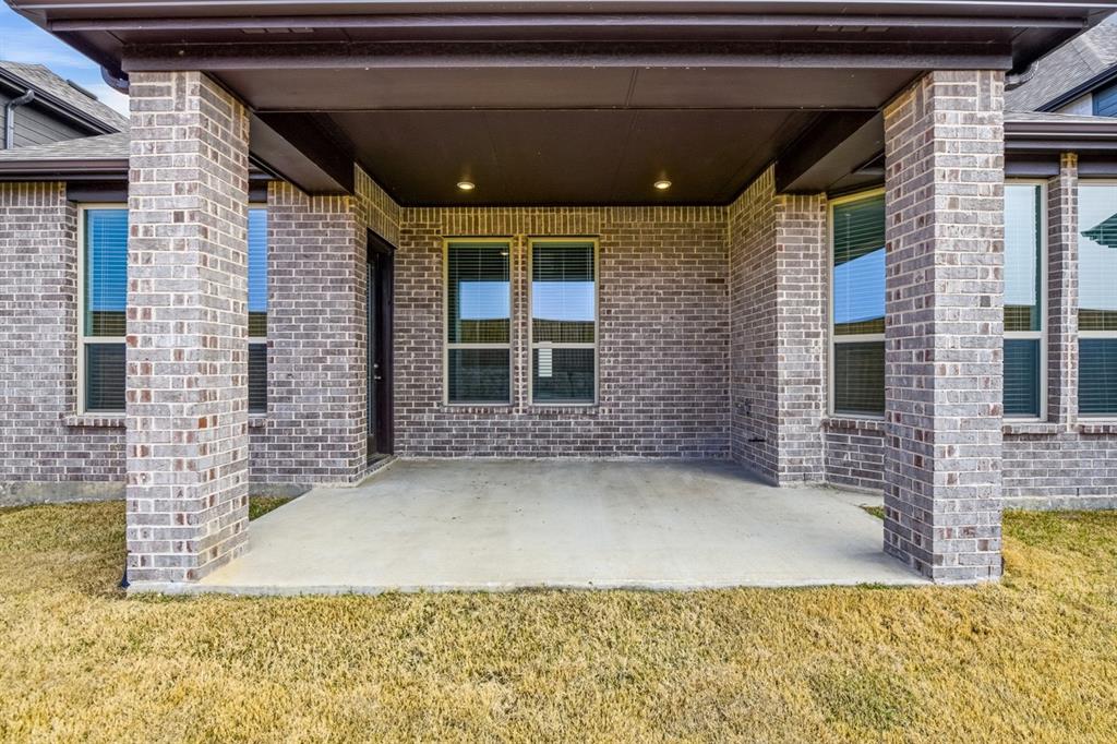 4107 Windy Point Court Oak Point, TX 75068 - Photo 28 of 30 a view of a brick house with many windows