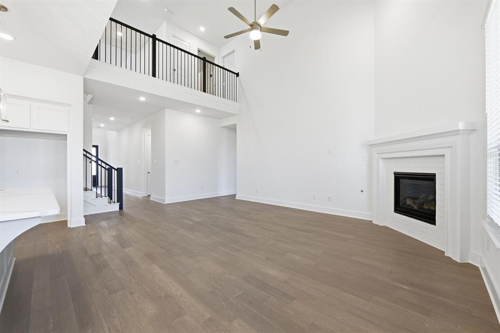 4107 Windy Point Court Oak Point, TX 75068 - Photo 9 of 30 a view of an empty room with a fireplace