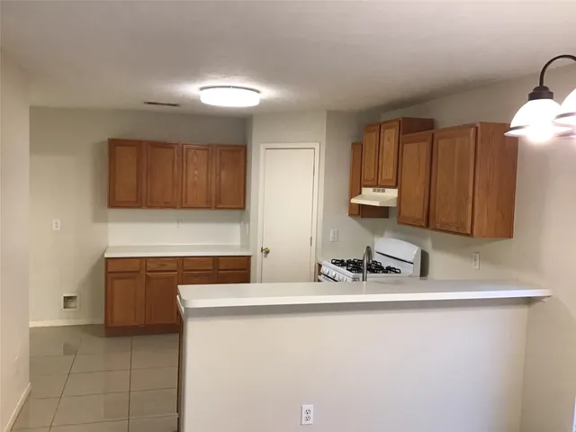 a kitchen with stainless steel appliances granite countertop a sink and a stove
