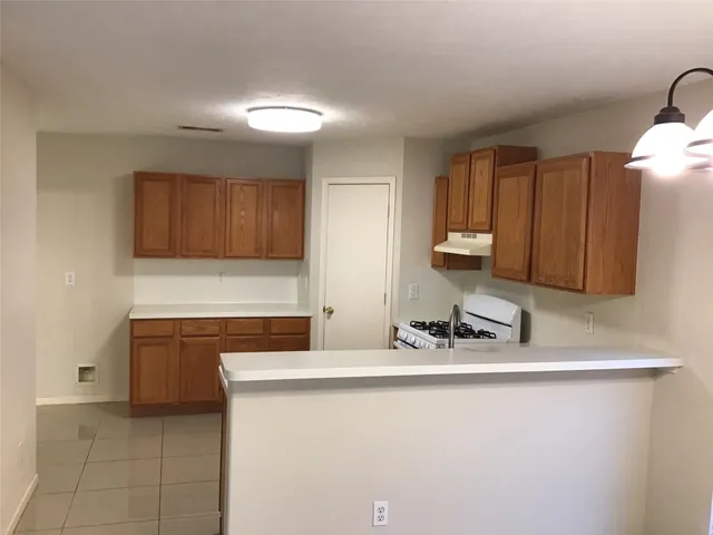 a kitchen with stainless steel appliances granite countertop a sink and a stove