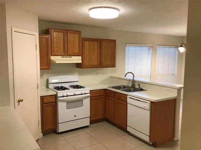 a kitchen with white cabinets stainless steel appliances and sink