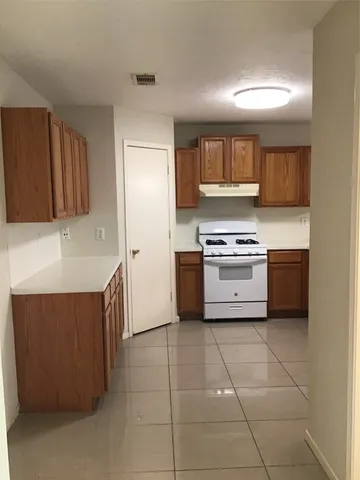 a kitchen with a cabinets and a stove top oven