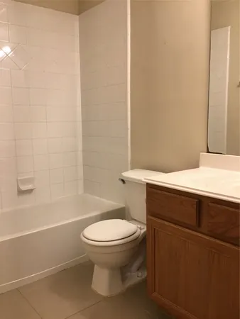 a bathroom with a toilet and a bath tub