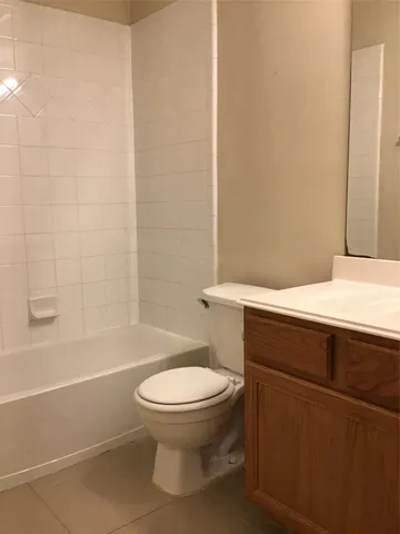 a bathroom with a toilet and a bath tub
