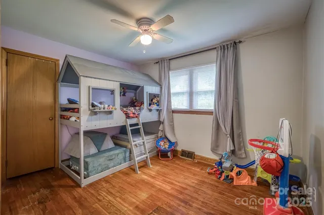 a view of a room with wooden floor and furniture