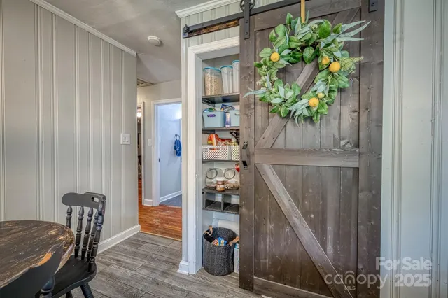 a view of a hallway with wooden floor and stairs