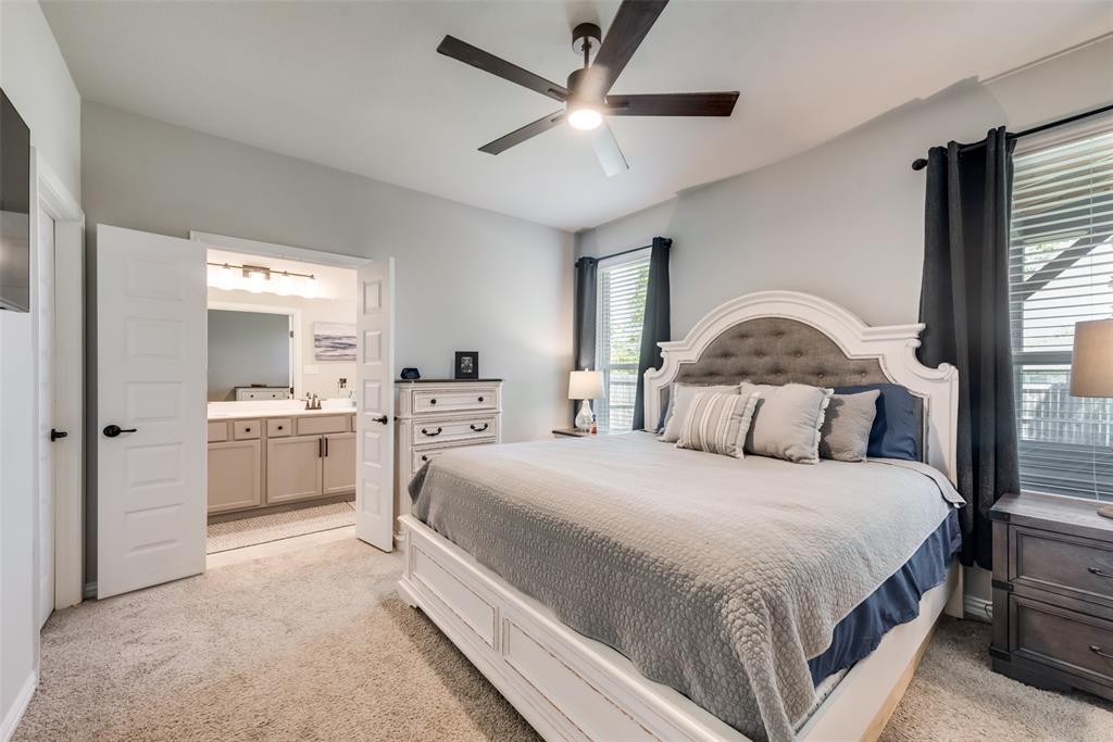 523 New Hope Street Terrell, TX 75160 - Photo 11 of 17 a bedroom with a large bed and a chandelier