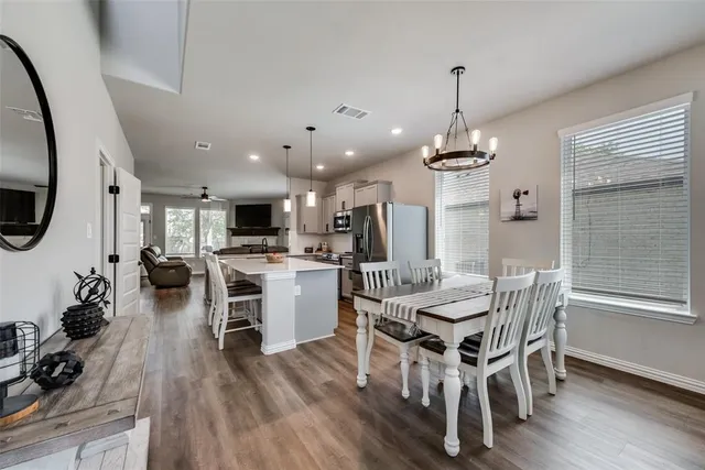 a view of a dining room with furniture wooden floor and a chandelier