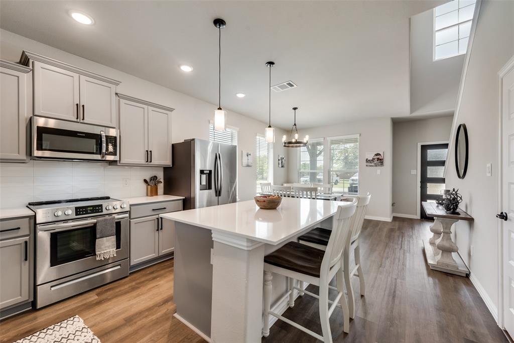 523 New Hope Street Terrell, TX 75160 - Photo 4 of 17 a kitchen with stainless steel appliances a stove a sink a microwave a refrigerator and cabinets