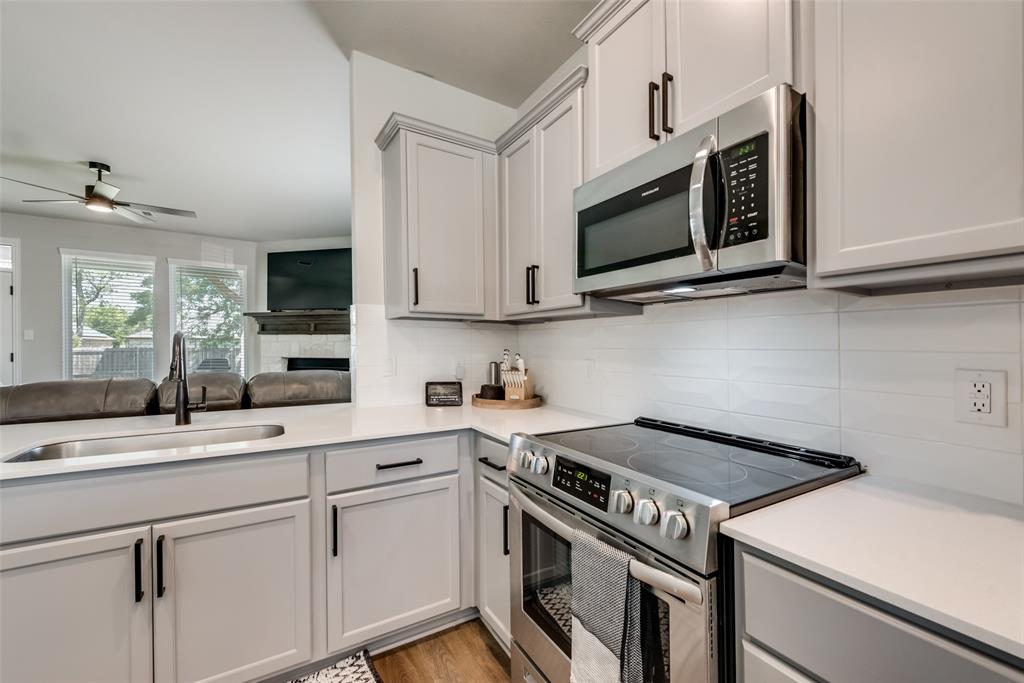 523 New Hope Street Terrell, TX 75160 - Photo 17 of 17 a kitchen with stainless steel appliances granite countertop a sink stove and microwave
