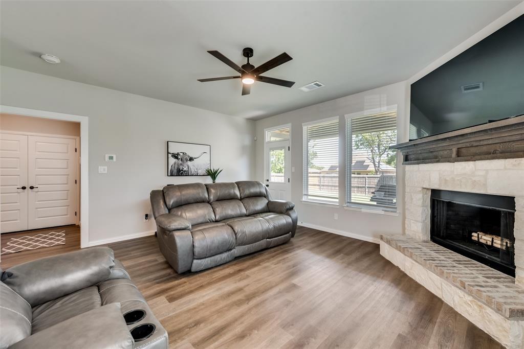 523 New Hope Street Terrell, TX 75160 - Photo 6 of 17 a living room with furniture a flat screen tv and a fireplace
