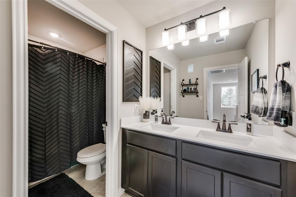 523 New Hope Street Terrell, TX 75160 - Photo 8 of 17 a bathroom with a sink a toilet and mirror