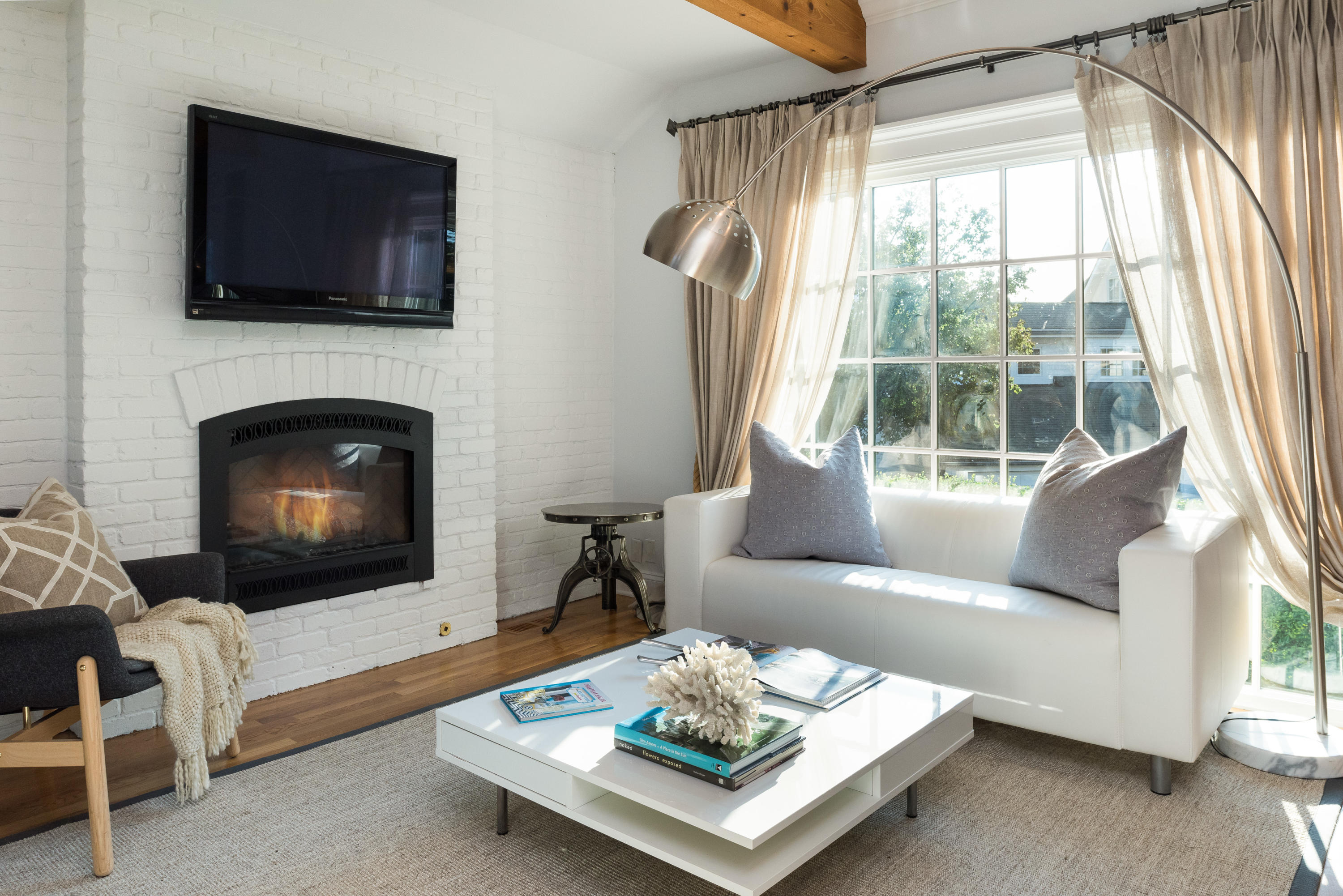 17 Rocky Point Road Rowayton, CT 06853 - Photo 10 of 25 a living room with furniture a fireplace and a flat screen tv