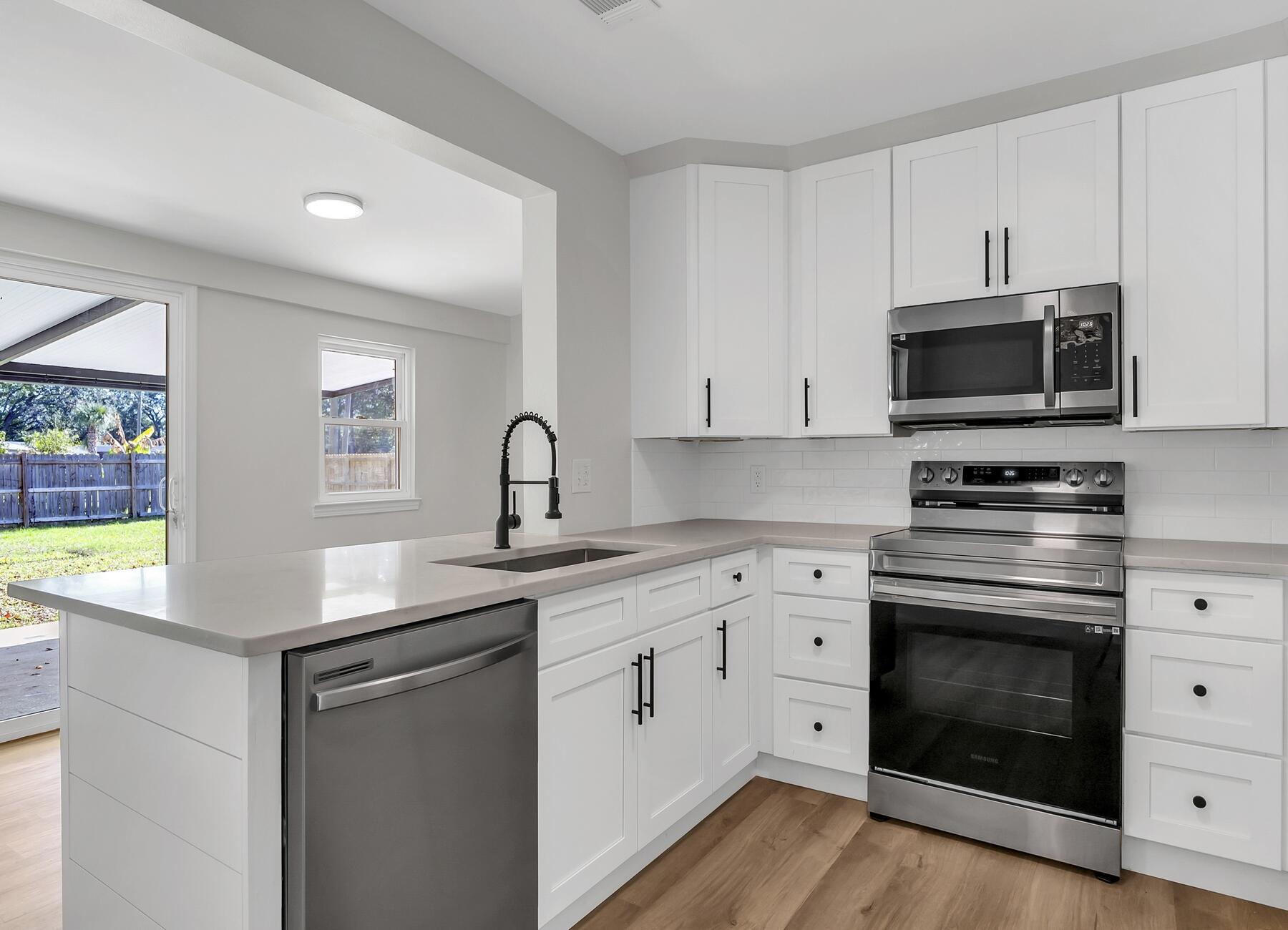 500 Ross Road Fort Walton Beach, FL 32547 - Photo 1 of 38 a kitchen with white cabinets stainless steel appliances and sink