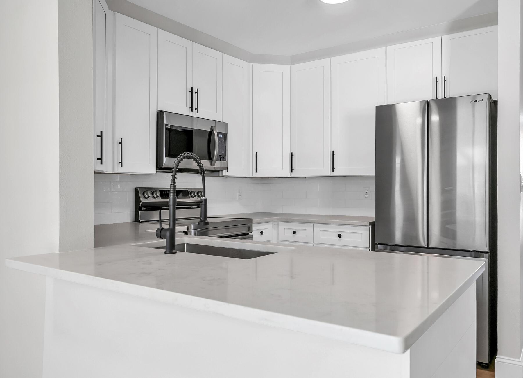 500 Ross Road Fort Walton Beach, FL 32547 - Photo 12 of 38 a kitchen with stainless steel appliances granite countertop a refrigerator and a stove top oven
