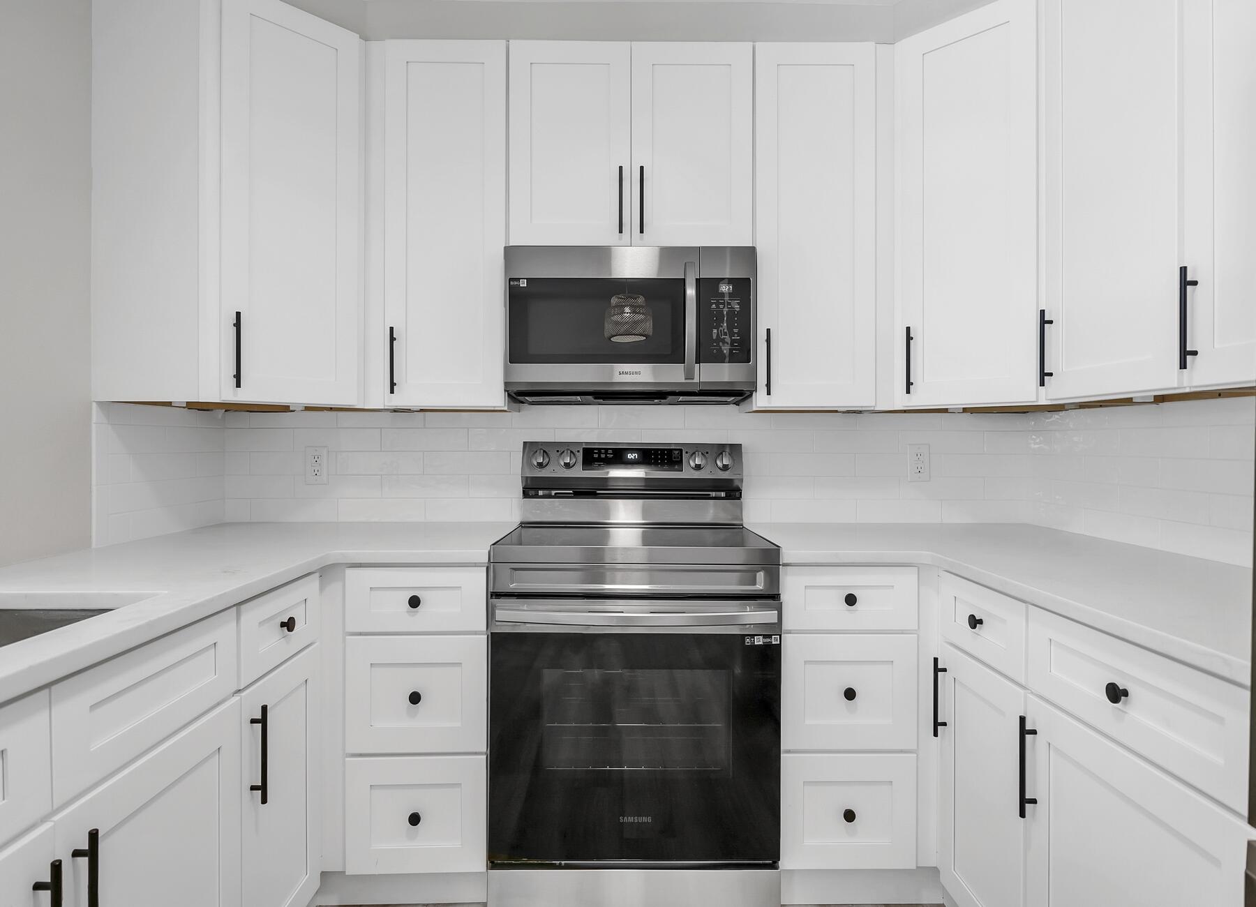 500 Ross Road Fort Walton Beach, FL 32547 - Photo 13 of 38 a kitchen with white cabinets and a stove with a sink