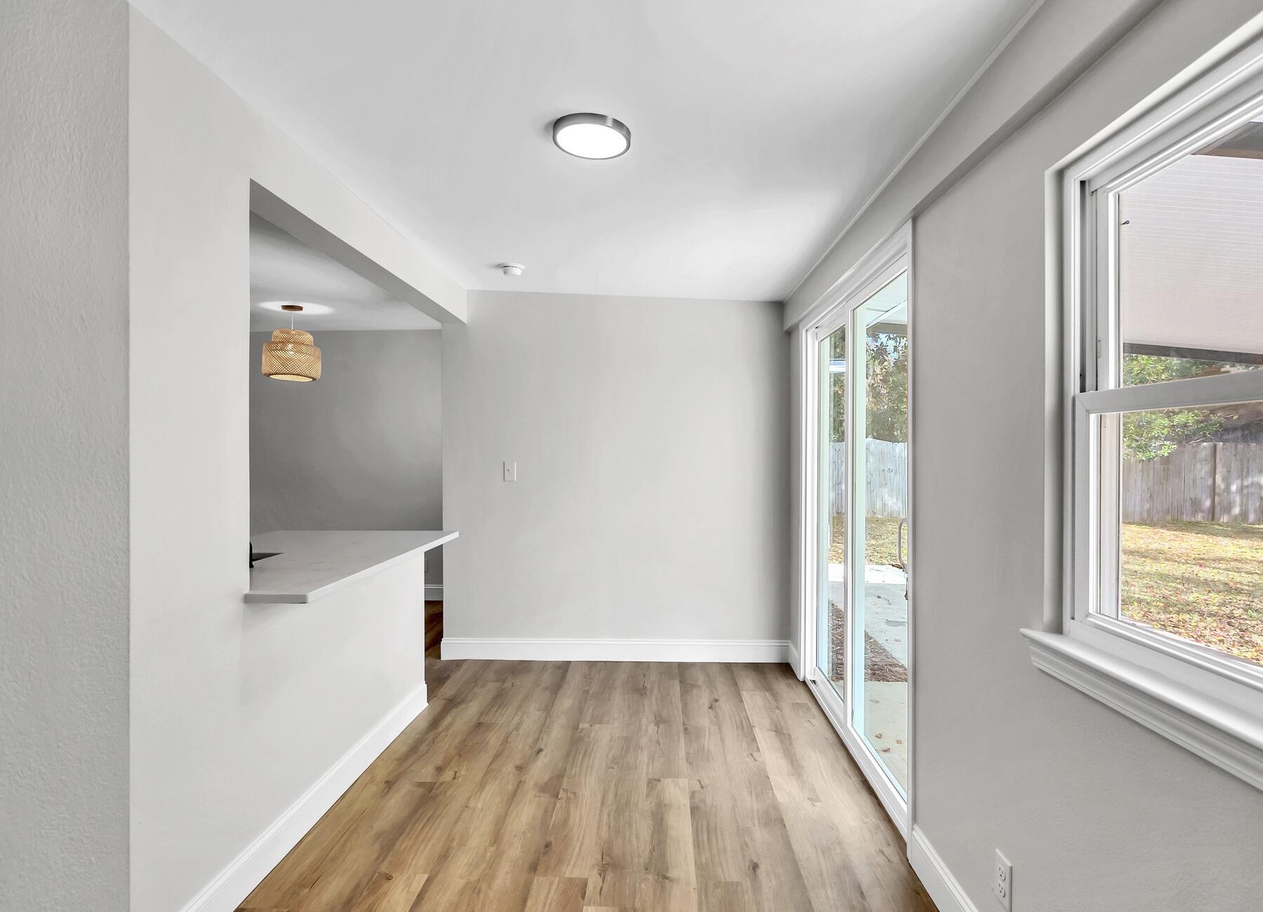 500 Ross Road Fort Walton Beach, FL 32547 - Photo 14 of 38 wooden floor in an empty room with a window