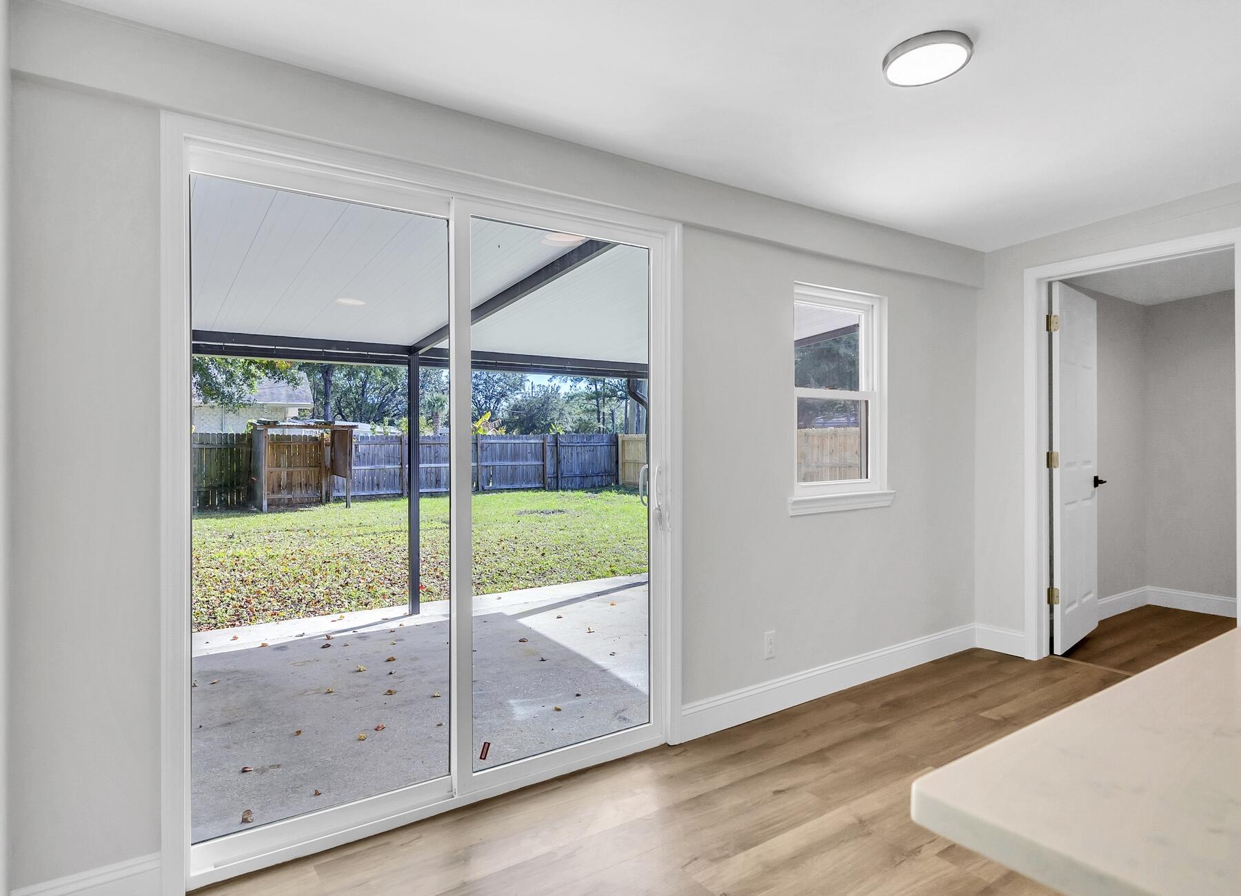 500 Ross Road Fort Walton Beach, FL 32547 - Photo 15 of 38 an empty room with wooden floor and windows