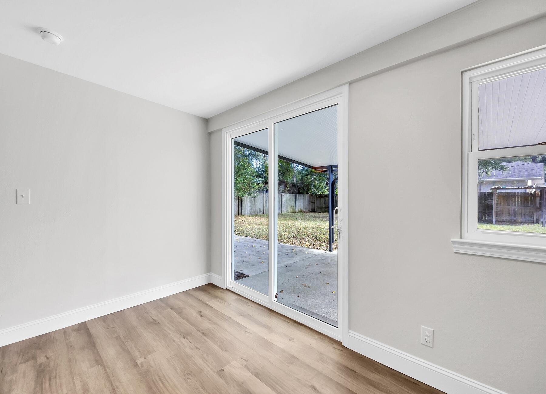 500 Ross Road Fort Walton Beach, FL 32547 - Photo 16 of 38 an empty room with sliding glass door