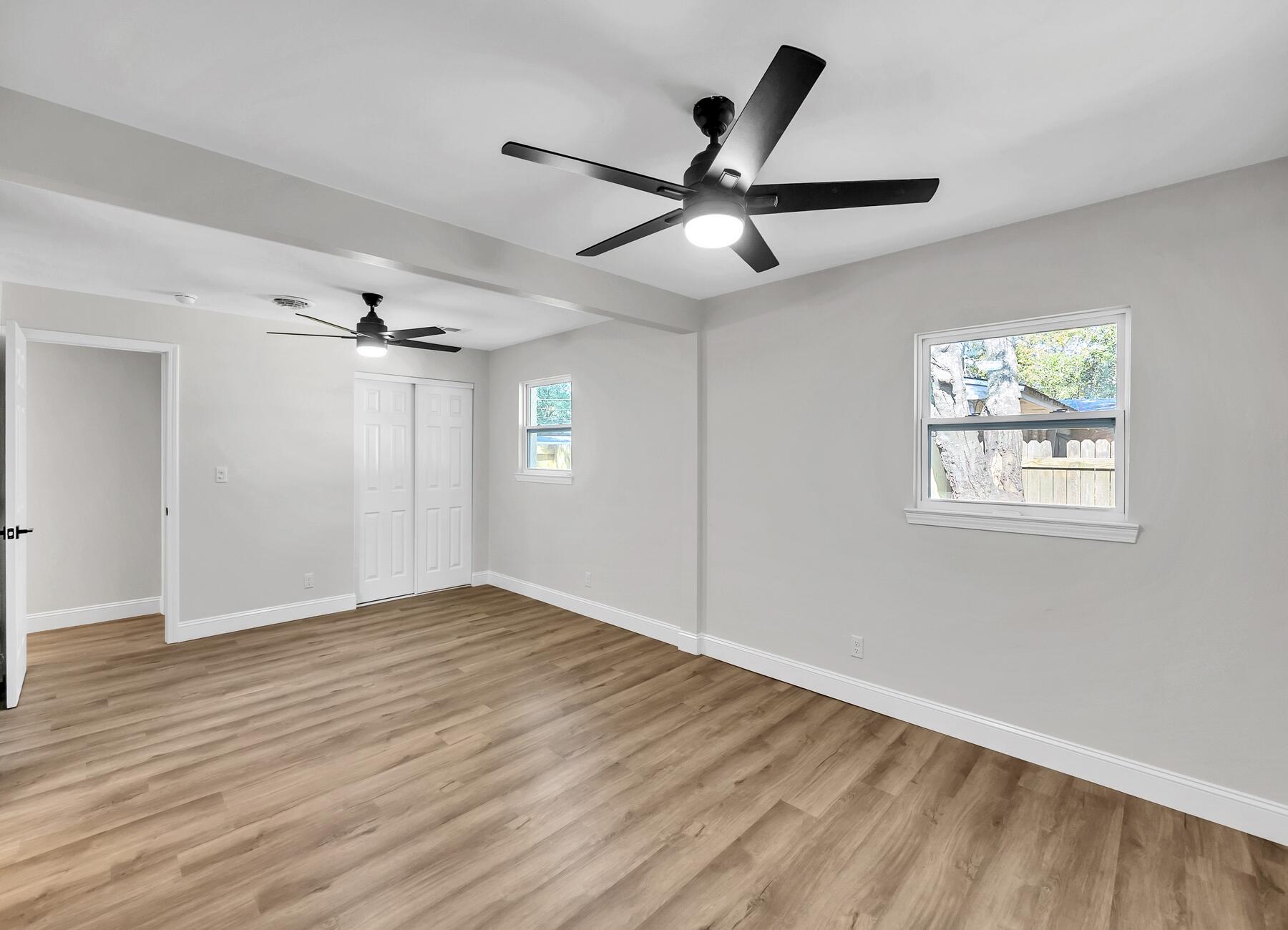500 Ross Road Fort Walton Beach, FL 32547 - Photo 20 of 38 a view of an empty room with wooden floor and a ceiling fan