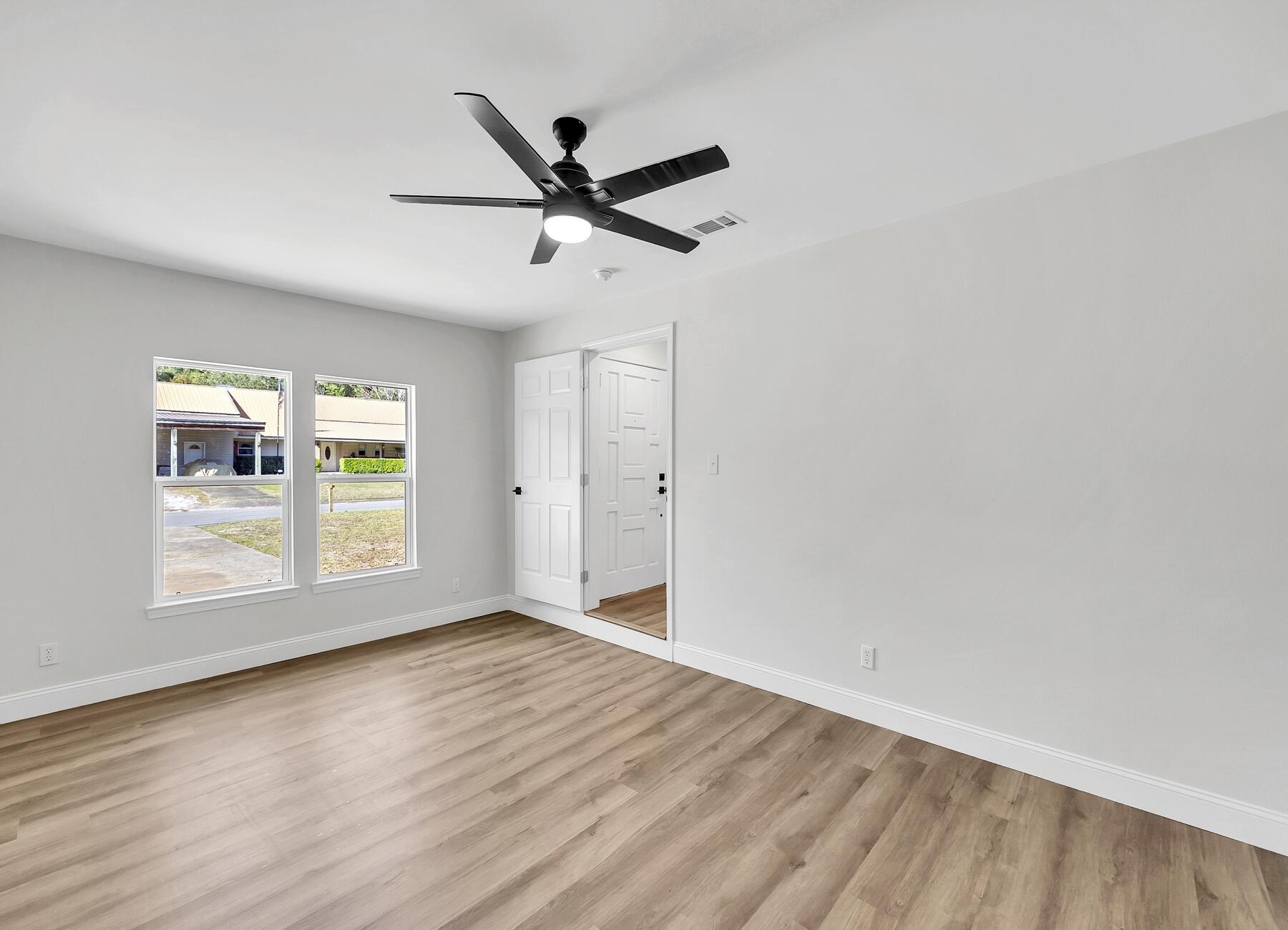 500 Ross Road Fort Walton Beach, FL 32547 - Photo 24 of 38 a view of empty room with wooden floor and fan
