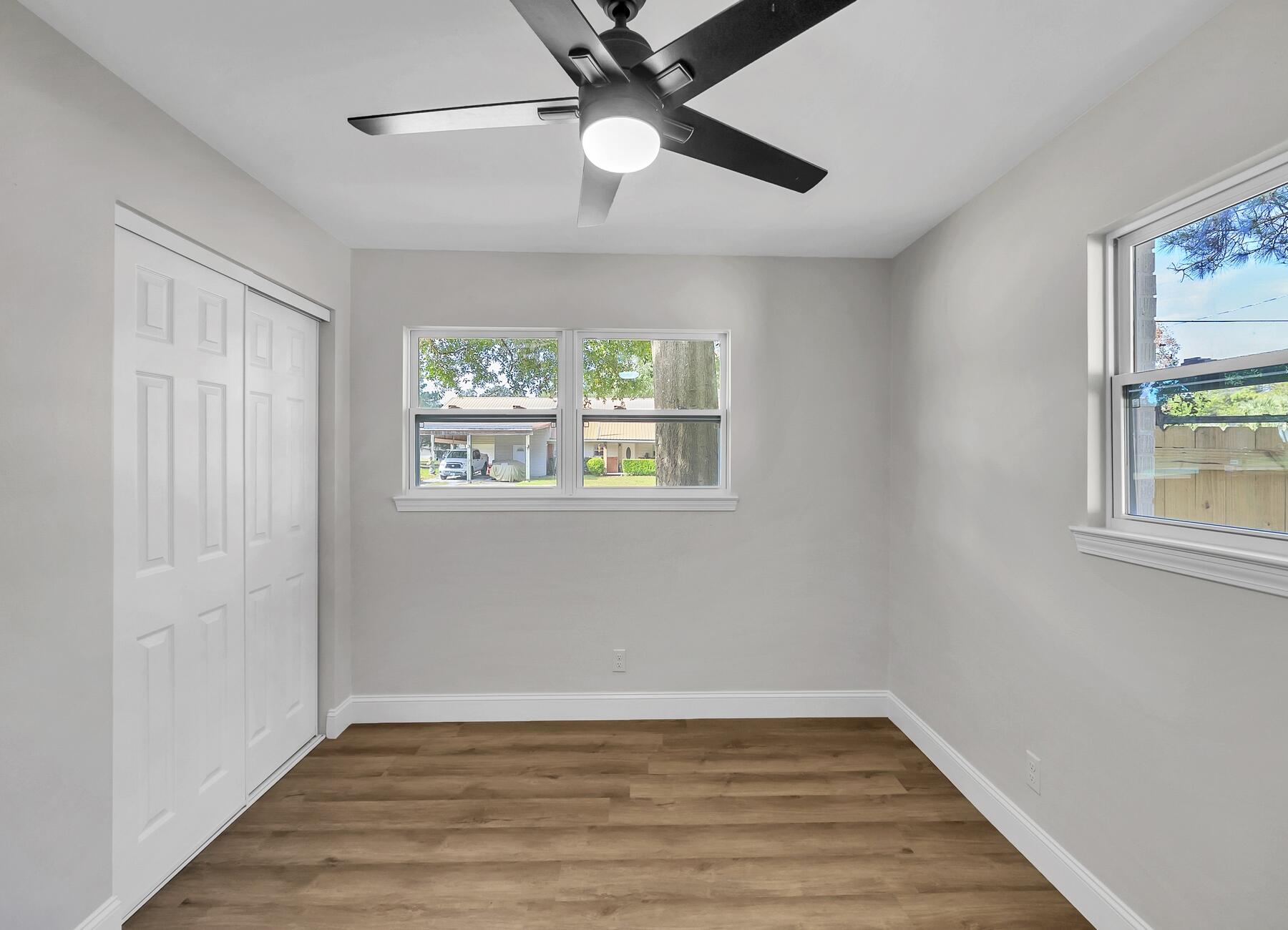 500 Ross Road Fort Walton Beach, FL 32547 - Photo 26 of 38 a view of an empty room with wooden floor and window