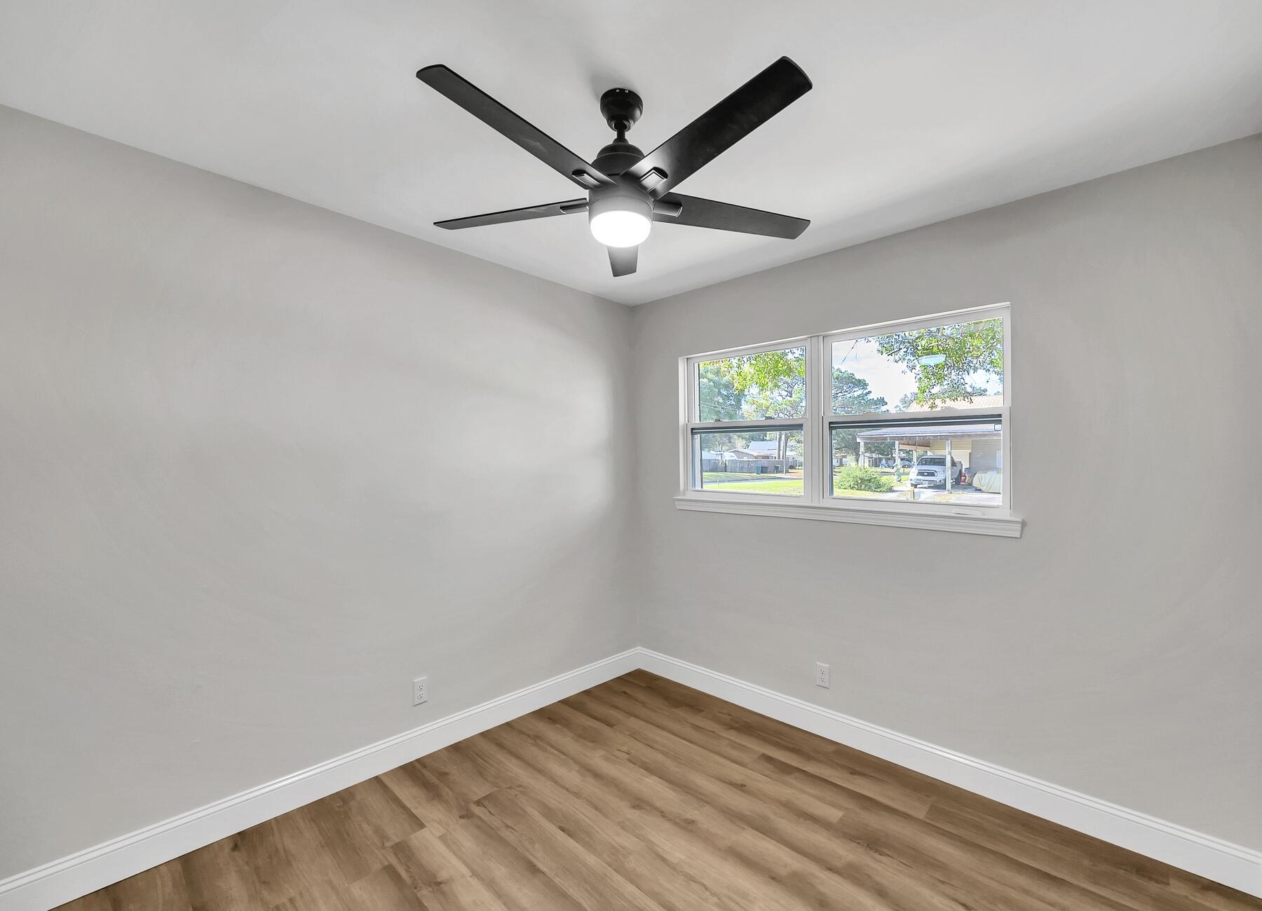 500 Ross Road Fort Walton Beach, FL 32547 - Photo 28 of 38 wooden floor in an empty room with a window