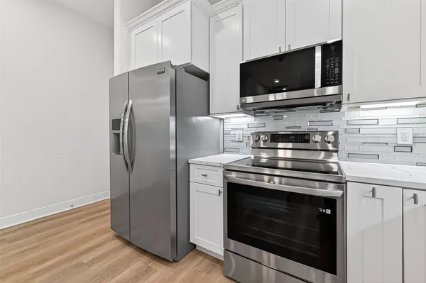 a kitchen with a stove microwave and refrigerator