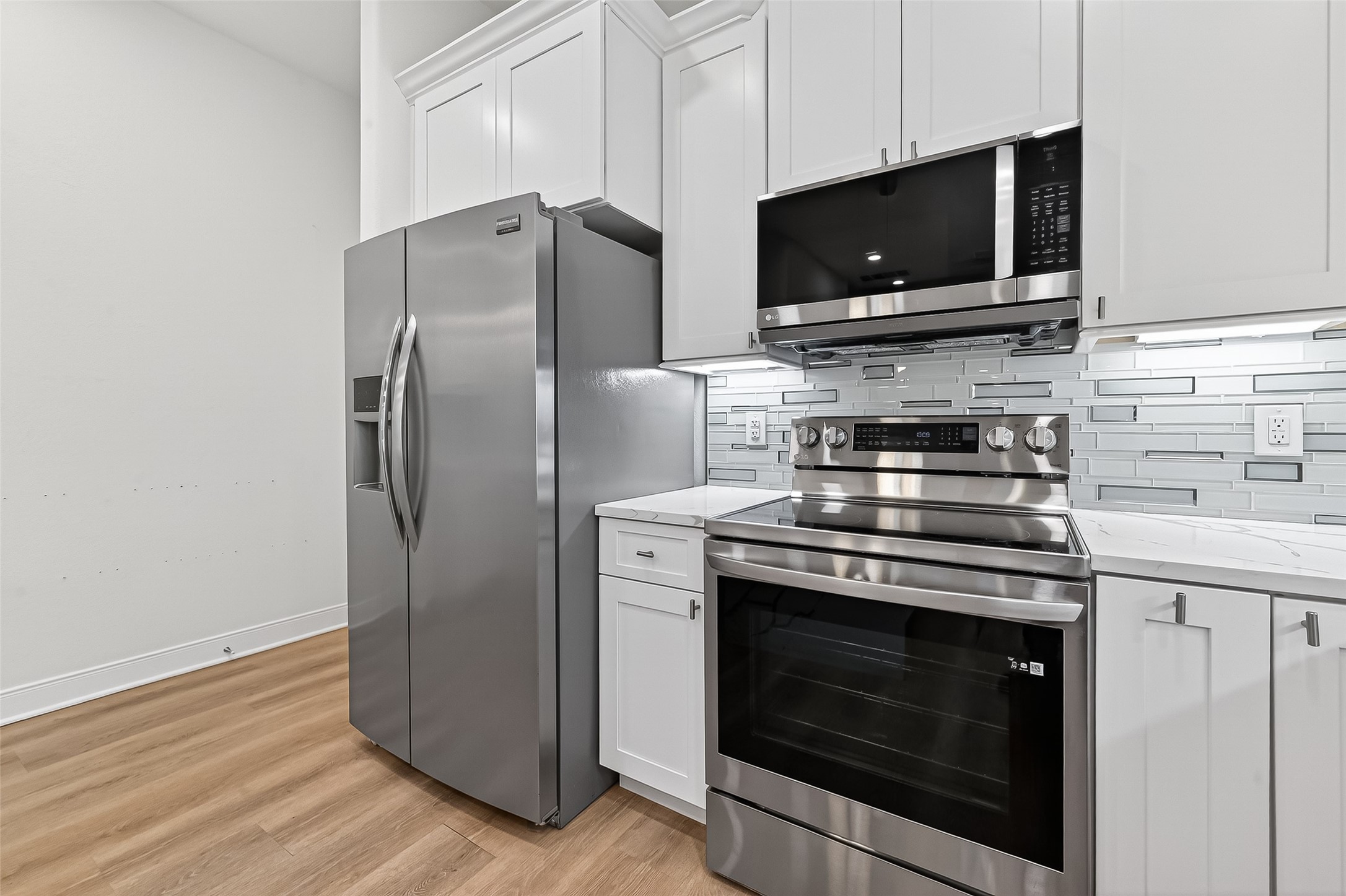 6630 Highrock Road Houston, TX 77092 - Photo 12 of 40 a kitchen with a stove microwave and refrigerator