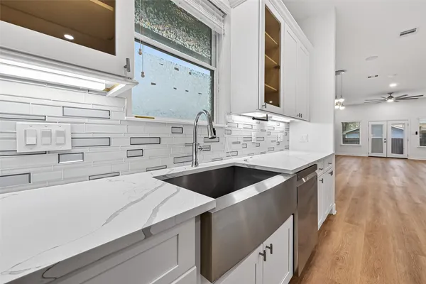a kitchen with cabinets a sink and appliances