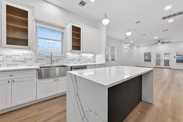 a kitchen with a sink stove and cabinets