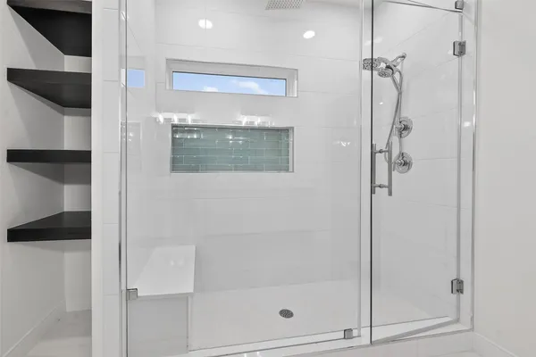 a bathroom with a glass shower door