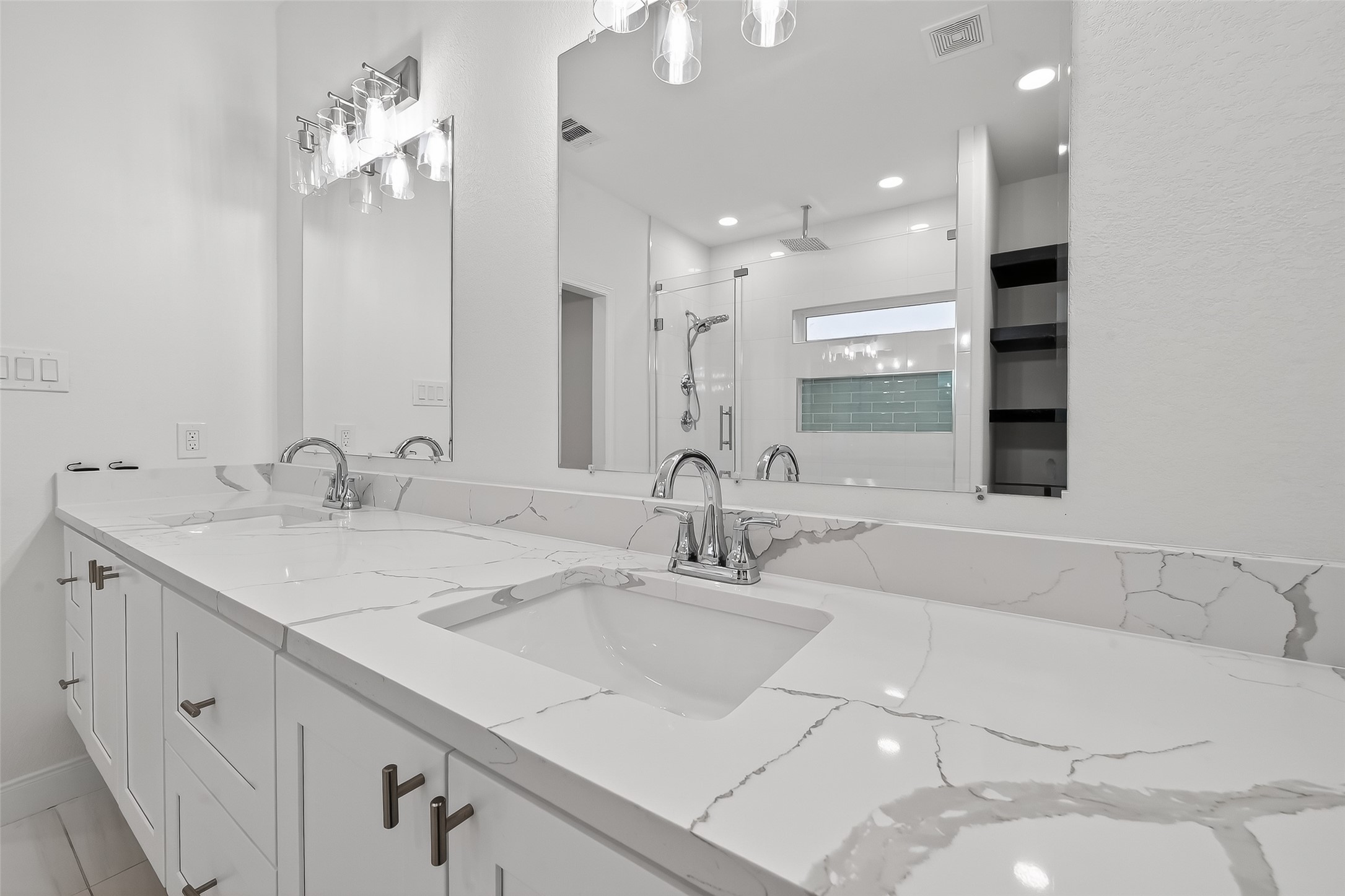 6630 Highrock Road Houston, TX 77092 - Photo 25 of 40 a bathroom with a double vanity sink and a mirror