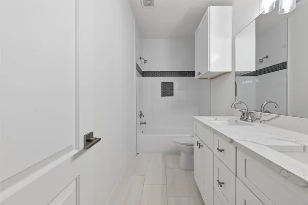a bathroom with a sink a toilet and vanity