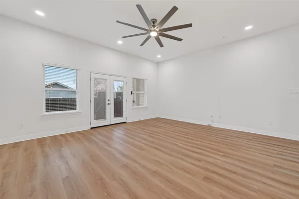wooden floor in an empty room with a window