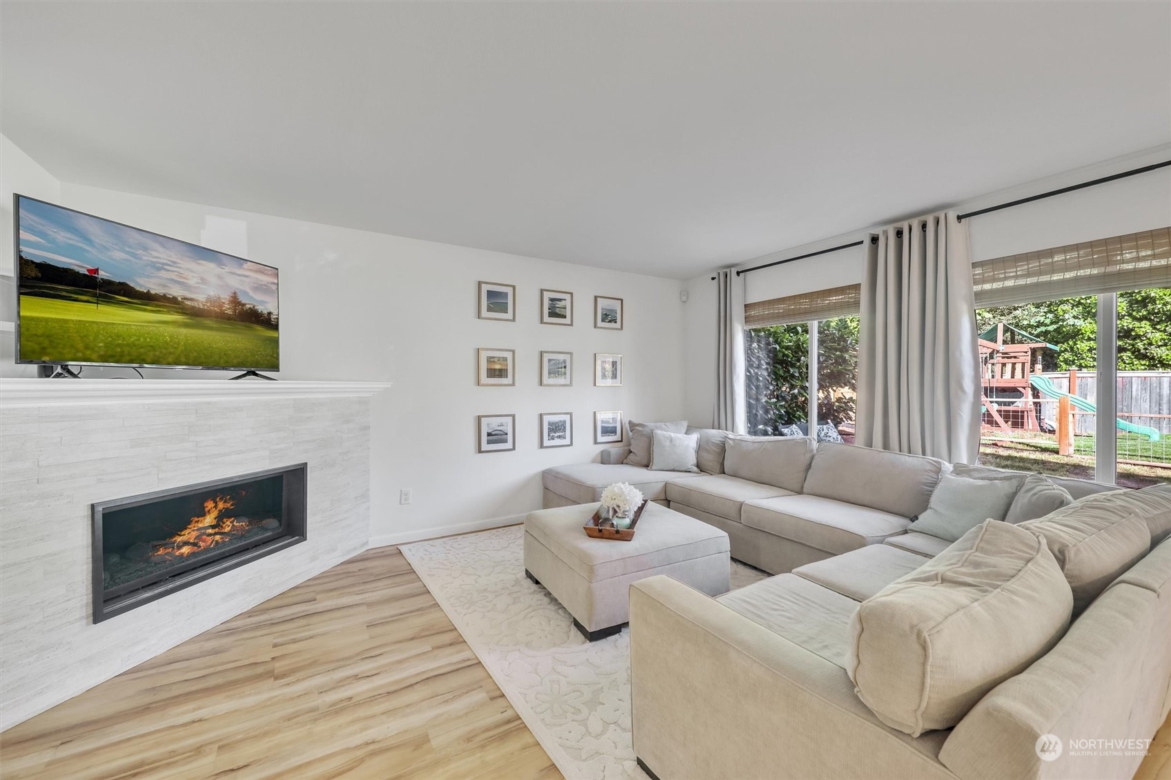 17427 92nd Avenue Northeast Bothell, WA 98011 - Photo 12 of 35 a living room with furniture flat screen tv and a fireplace