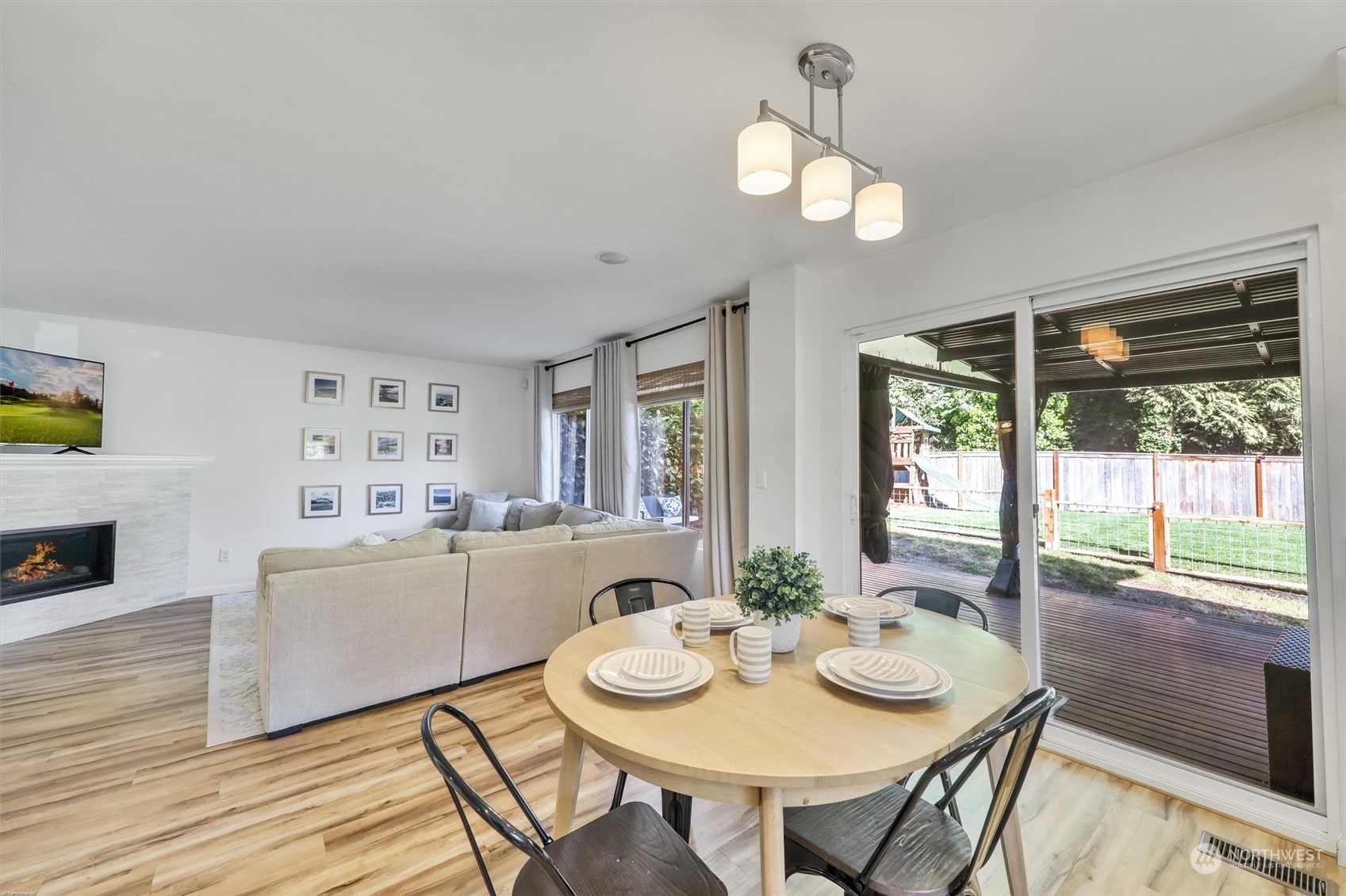 17427 92nd Avenue Northeast Bothell, WA 98011 - Photo 13 of 35 a view of a dining room with furniture a chandelier and wooden floor
