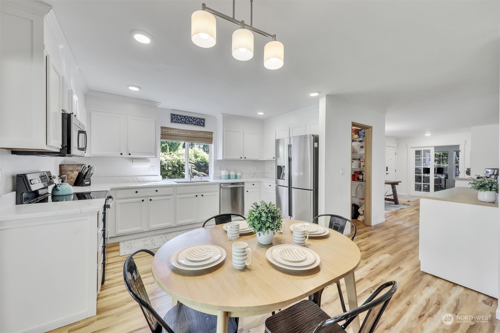 17427 92nd Avenue Northeast Bothell, WA 98011 - Photo 17 of 35 a kitchen with stainless steel appliances kitchen island granite countertop a kitchen island a stove a table and chairs