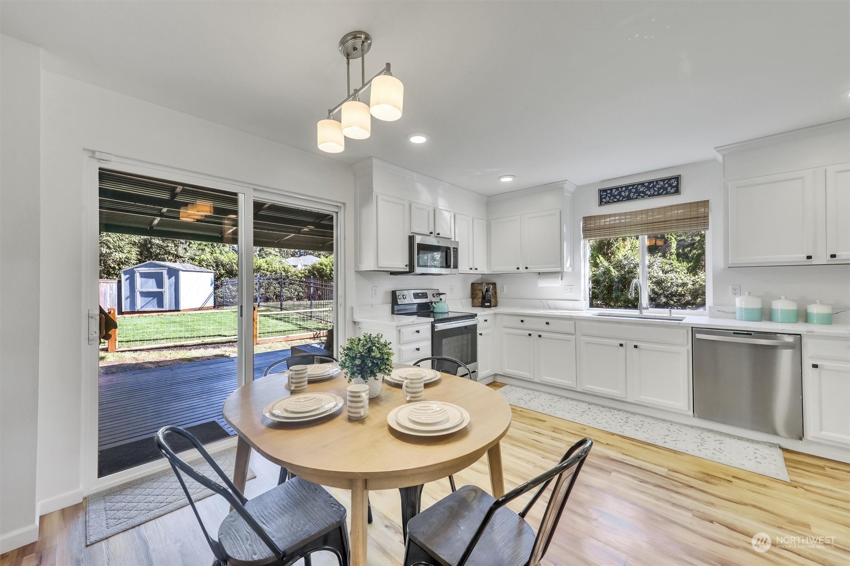 17427 92nd Avenue Northeast Bothell, WA 98011 - Photo 9 of 35 a view of a dining room with furniture a kitchen and chandelier