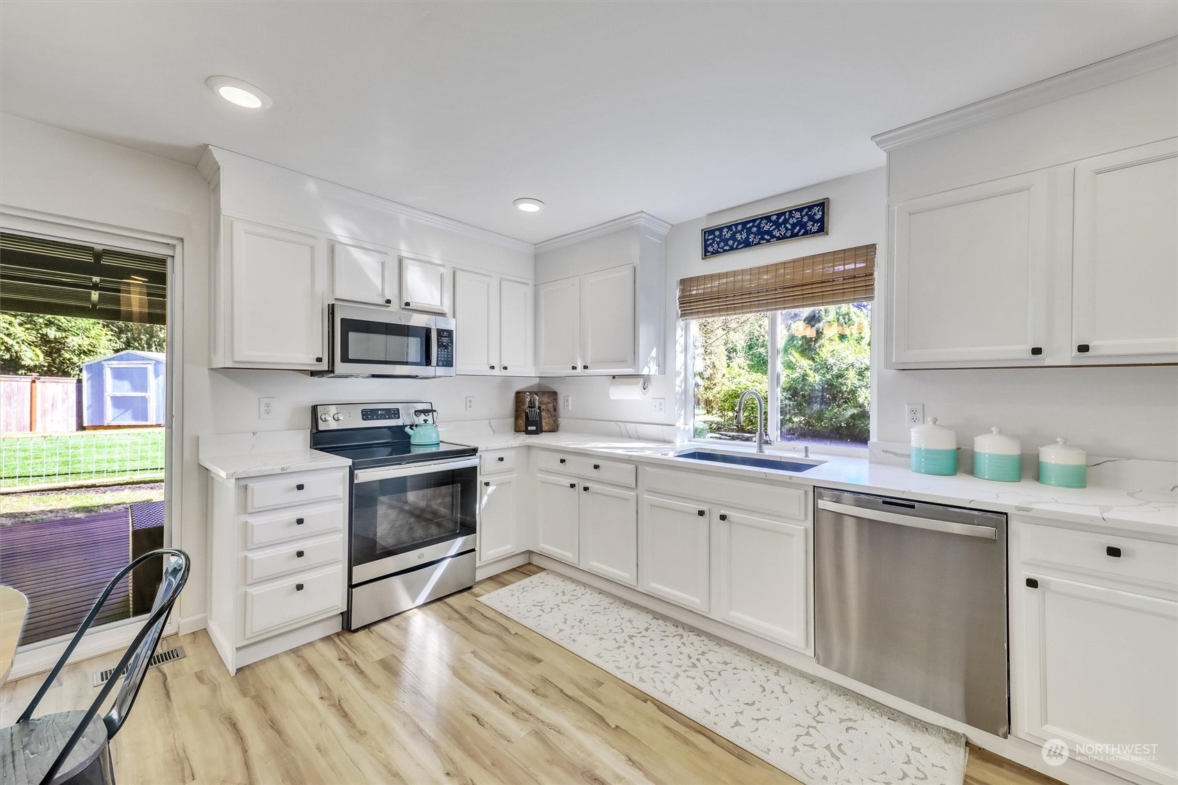17427 92nd Avenue Northeast Bothell, WA 98011 - Photo 10 of 35 a kitchen with white cabinets and white appliances