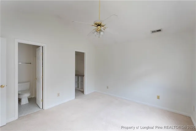 a view of a chandelier fan and refrigerator